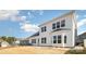 Back exterior featuring ample windows, neutral paint, and a well manicured lawn at 3105 Bonterra Blvd, Indian Trail, NC 28079