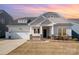 Charming single-Gathering home boasts a manicured lawn, stone accents, and a two-car garage at 3105 Bonterra Blvd, Indian Trail, NC 28079