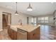 Stylish kitchen featuring a granite center island, stainless dishwasher, and wood flooring at 3105 Bonterra Blvd, Indian Trail, NC 28079