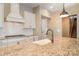 Open kitchen features granite counters, stainless appliances, and a functional center island at 3105 Bonterra Blvd, Indian Trail, NC 28079