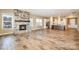 Bright, open living room featuring a stone fireplace and an adjacent kitchen with stainless steel appliances at 3105 Bonterra Blvd, Indian Trail, NC 28079