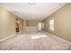 Large living room featuring neutral walls and plush carpeting at 3105 Bonterra Blvd, Indian Trail, NC 28079