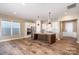 Bright and open living space showcases wood floors, a kitchen island, and stainless appliances at 3105 Bonterra Blvd, Indian Trail, NC 28079