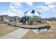 Community playground with slides, climbing structures, and benches for relaxing at 3105 Bonterra Blvd, Indian Trail, NC 28079