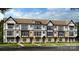 New townhome construction featuring multi-story layout with brick and siding accents, and lush landscaping at 3106 Stelfox St, Charlotte, NC 28262