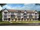 An exterior elevation showcasing multiple townhouse units with black trim and landscaping at 3114 Stelfox St, Charlotte, NC 28262