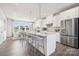 Bright kitchen with stainless steel appliances, marble countertops, an island, and gray chairs at 3114 Stelfox St, Charlotte, NC 28262