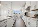 Modern kitchen boasts stainless steel appliances, white cabinets, and a spacious island, ideal for cooking and entertaining at 3114 Stelfox St, Charlotte, NC 28262