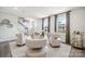 Contemporary living room with modern seating, neutral colors, large windows and staircase at 3114 Stelfox St, Charlotte, NC 28262