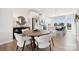 Bright dining area features modern lighting, wood floors, and access to outdoor space at 3118 Stelfox St, Charlotte, NC 28262