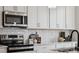Modern kitchen features stainless steel appliances, subway tile backsplash, and white cabinetry at 3118 Stelfox St, Charlotte, NC 28262