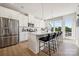 Modern kitchen with white cabinets, large island and seating, and stainless steel appliances at 3118 Stelfox St, Charlotte, NC 28262