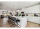 Open-concept kitchen with white cabinets, large island and seating, and stainless steel appliances at 3118 Stelfox St, Charlotte, NC 28262