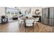 Open-concept living area with hardwood floors, modern furniture, and stainless steel appliances at 3118 Stelfox St, Charlotte, NC 28262