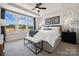 Bright main bedroom featuring three windows, a tray ceiling and a patterned accent wall at 3118 Stelfox St, Charlotte, NC 28262