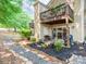 Exterior shot showing patio and decks with peaceful backyard and rock path enhancing the home's appeal at 3308 Selwyn Farms Ln # 2, Charlotte, NC 28209