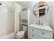 Bathroom with a white vanity, round mirror, decorative tiling, and a shower-tub combination at 3308 Selwyn Farms Ln # 2, Charlotte, NC 28209