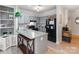 Kitchen with gray cabinets, an island, a modern refrigerator, and open shelving at 3308 Selwyn Farms Ln # 2, Charlotte, NC 28209