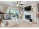 Bright living room featuring a fireplace, TV, mirror, and sliding glass doors leading to the backyard at 3308 Selwyn Farms Ln # 2, Charlotte, NC 28209