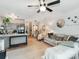 Bright living room featuring hardwood floors, stylish decor, a ceiling fan, and a comfortable sofa at 3308 Selwyn Farms Ln # 2, Charlotte, NC 28209