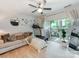 Sun-filled living area with a treadmill and sliding glass doors leading to outdoor space, complete with light-colored wood flooring at 3308 Selwyn Farms Ln # 2, Charlotte, NC 28209