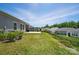 The home features a backyard with a concrete patio and green grass that extends to a fence line at 3833 Isenhour Rd, Kannapolis, NC 28081