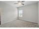 The bedroom features neutral carpeting and paint and a window that provides plenty of natural light at 3833 Isenhour Rd, Kannapolis, NC 28081