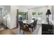 Bright dining area boasts a dining table with woven chairs, natural light and access to the backyard at 3833 Isenhour Rd, Kannapolis, NC 28081
