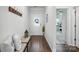 Bright entryway with hardwood floors, coat rack, and views into the open-concept living space at 3833 Isenhour Rd, Kannapolis, NC 28081