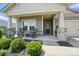 Charming front porch with rocking chairs, stone accents, and a decorative wreath on the front door at 3833 Isenhour Rd, Kannapolis, NC 28081
