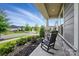 Relaxing front porch view with rocking chairs and stone pillar details, perfect for enjoying the neighborhood at 3833 Isenhour Rd, Kannapolis, NC 28081