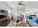 Comfortable living room featuring a ceiling fan and an open layout flowing into the dining and kitchen areas at 3833 Isenhour Rd, Kannapolis, NC 28081