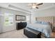 Bright main bedroom featuring a tufted headboard, tray ceiling, and natural light at 3833 Isenhour Rd, Kannapolis, NC 28081
