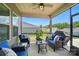 This relaxing screened-in patio features comfortable furniture, a ceiling fan, and views of the backyard at 3833 Isenhour Rd, Kannapolis, NC 28081