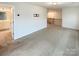 Spacious bonus room has neutral carpet with staircase and doorway into bathroom at 4105 Galloway Park Dr, Charlotte, NC 28262
