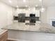 Modern kitchen with granite countertops, stainless steel appliances, and center island at 4105 Galloway Park Dr, Charlotte, NC 28262