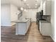 Modern kitchen with granite countertops, stainless steel appliances, and wooden floor at 4105 Galloway Park Dr, Charlotte, NC 28262