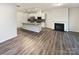 Open concept living area featuring hardwood floors and access to a modern kitchen at 4105 Galloway Park Dr, Charlotte, NC 28262