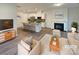 Bright living room showcasing modern furniture, fireplace, and adjacent open kitchen at 4105 Galloway Park Dr, Charlotte, NC 28262