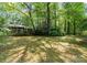 Lush backyard with mature trees, offering ample space for outdoor activities and relaxation at 4417 Walter Nelson Rd, Mint Hill, NC 28227