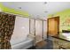 Bright bathroom featuring a tub, shower, and single vanity with retro green walls at 4417 Walter Nelson Rd, Mint Hill, NC 28227