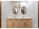 Charming bathroom with wallpaper, double sinks, and decorative mirrors and lighting at 4417 Walter Nelson Rd, Mint Hill, NC 28227