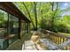 Relaxing deck area with comfortable lounge chairs and views of the surrounding trees at 4417 Walter Nelson Rd, Mint Hill, NC 28227