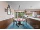 Traditional dining area with wood paneling, chandelier, and a bay window providing natural light at 4417 Walter Nelson Rd, Mint Hill, NC 28227