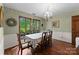 Traditional dining room with hardwood floors, two windows, and classic wood furniture and decor at 4417 Walter Nelson Rd, Mint Hill, NC 28227