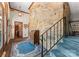 An inviting entryway with stone accent wall, carpeted stairs, and a glimpse into adjacent rooms at 4417 Walter Nelson Rd, Mint Hill, NC 28227