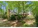 Wood and stone home is surrounded by a mature forest, creating a peaceful and private setting at 4417 Walter Nelson Rd, Mint Hill, NC 28227