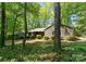 The exterior of a home is surrounded by a mature forest, offering lots of shade at 4417 Walter Nelson Rd, Mint Hill, NC 28227