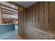 Hallway with coat hooks and bench seating leading to living room with beamed ceilings and modern lighting at 4417 Walter Nelson Rd, Mint Hill, NC 28227