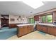 A retro kitchen features wood cabinets, a skylight, and an adjacent dining area with views of the yard at 4417 Walter Nelson Rd, Mint Hill, NC 28227